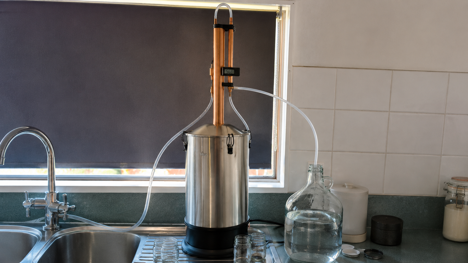 Still Spirits Turbo 500 reflux still running on a kitchen bench with the condenser thermometer visible