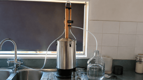 Still Spirits Turbo 500 reflux still running on a kitchen bench with the condenser thermometer visible