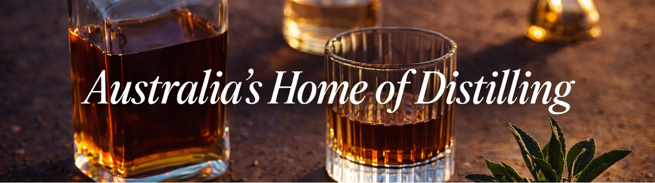 Alcohol bottles and a glass with whisky on a dark surface, with text 'Australia's Home of Distilling'